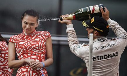 Hamilton wins Chinese GP but under fire for spraying hostess